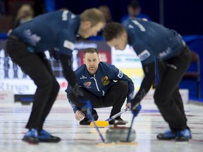 Skip Brad Gushue watches second Brett Gallant (right) and lead Geoff Walker (left) sweep his shot during 8th end action against Team Morris at the Olympic curling trials, Monday, December 4, 2017 in Ottawa.