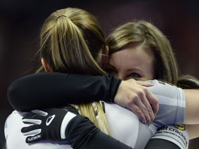 Rachel Homan, right, and Lisa Weagle hug each other after winning the 2017 Roar of the Rings Canadian Olympic Trials in Ottawa on Sunday, Dec. 10, 2017. Homan and her Ottawa-based curling team will represent Canada at the Winter Olympics.