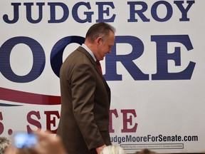 U.S. Senate candidate Roy Moore leaves the stage after giving a speech at the end of an election-night watch party.