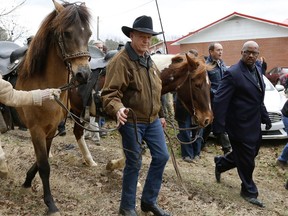 U.S. Senate candidate Roy Moore walks his horse after voting in the Alabama senatorial election, Tuesday, Dec. 12, 2017, in Gallant, Ala.
