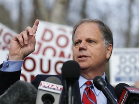 Democratic candidate for U.S. Senate Doug Jones speaks to reporters after casting his ballot Tuesday, Dec. 12, 2017, in Mountain Brook , Ala.  Jones is facing Republican Roy Moore.