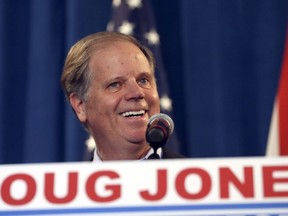 Sen.-elect Doug Jones jokes with reporters during a news conference Wednesday, Dec. 13, 2017, in Birmingham, Ala. Weary national Republicans breathed a collective sigh of relief on Wednesday, a day after voters knocked out their own party's scandal-plagued candidate in deep-red Alabama.