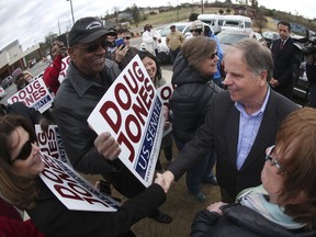 Democratic candidate for U.S. Senate Doug Jones greets supporters and voters outside Bethal Baptist Church Tuesday, Dec. 12, 2017, in Birmingham , Ala.   Jones is facing Republican Roy Moore.