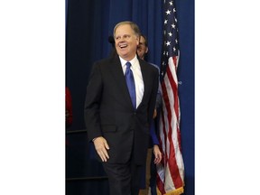 Democrat Doug Jones smiles as he arrives to speak Tuesday, Dec. 12, 2017, in Birmingham, Ala. In a stunning victory aided by scandal, Jones won Alabama's special Senate election, beating back history, an embattled Republican opponent and President Donald Trump, who urgently endorsed GOP rebel Roy Moore despite a litany of sexual misconduct allegations.