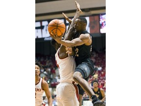 Central Florida's Chance McSpadden, right, shoots over Alabama's Daniel Giddens, left, during the first half of an NCAA college basketball game Sunday, Dec. 3, 2017, in Tuscaloosa, Ala.