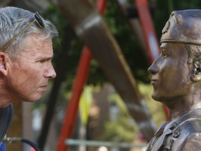 FILE- In this Nov. 3, 2017 file photo, sculptor, Tuscaloosa resident and retired Marine Col. Lee Busby checks the image of Mark Forester he sculpted outside the University of Alabama Foundry in Tuscaloosa, Ala. Write-in votes could matter in Alabama's Senate race between Republican Roy Moore and Democrat Doug Jones. Sculptor Lee Busby is running as a write-in with several others.