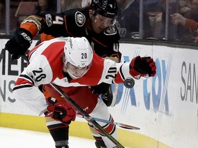Carolina Hurricanes right wing Sebastian Aho (20) vies for the puck with Anaheim Ducks defenseman Cam Fowler during the first period of an NHL hockey game in Anaheim, Calif., Monday, Dec. 11, 2017.