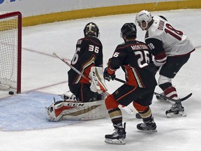 Anaheim Ducks goalie John Gibson (36), Ducks defenseman Josh Manson (42) and Arizona Coyotes center Christian Dvorak (18) watch a goal by left winger Brendan Perlini in the first period of an NHL hockey game in Anaheim, Calif., Sunday, Dec. 31, 2017.