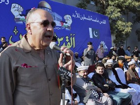 In this Friday, Dec. 29, 2017, photo, Palestinian Ambassador to Pakistan Walid Abu Ali addresses during an anti-U.S. rally in Rawalpindi, Pakistan. The Palestinians have withdrawn their envoy to Pakistan, Ali, after he appeared at a rally with a radical cleric linked to the 2008 Mumbai attacks.