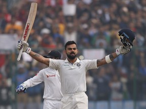 India's captain Virat Kohli celebrates after scoring a double century during the second day of their third test cricket match against Sri Lanka in New Delhi, India, Sunday, Dec. 3, 2017.