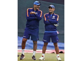 India's head coach Ravi Shastri, left, speaks to wicketkeeper Mahendra Singh Dhoni at nets during a practice session ahead of their second one-day international cricket match against Sri Lanka in Mohali, India, Tuesday, Dec. 12, 2017.