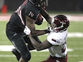 Troy cornerback Jawon McDowell (27) tackles Arkansas State wide receiver Chris Murray (14) during the second quarter of an NCAA college football game Saturday, Dec. 2, 2017, in Jonesboro, Ark.