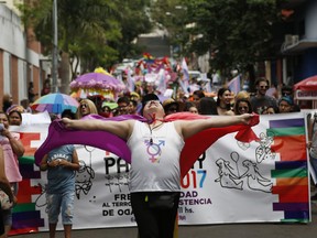 In this Sept. 30, 2017 photo, members of a gay organization "Panambi," meaning butterfly in Guarani, protest the killing of transvestite prostitutes and demand equal rights for gays during the annual LGBQT parade in Asuncion, Paraguay. Discrimination against gay and transgender people has traditionally been the norm in Paraguay, and activists say it's becoming more evident since the conservative government recently banned the teaching of sexual diversity in schools.