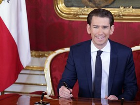 Sebastian Kurz, Austria's chancellor, poses for photographs as he signs a document during the inauguration of the new federal government in Vienna on Dec. 18, 2017. MUST CREDIT: Bloomberg photo by Lisi Niesner.