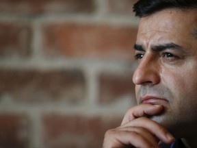FILE-In this Monday, May 11, 2015 file photo Selahattin Demirtas, co-chair of Turkey's pro-Kurdish opposition People's Democratic Party (HDP) talks during an interview with the Associated Press in Istanbul. A trial began Thursday, Dec. 7, 2017 against the imprisoned leader of Turkey's pro-Kurdish opposition party on terror charges has opened in the Turkish capital. Prosecutors are seeking a total of 142 years in prison for Peoples' Democracy Party -- or HDP -- co-chairman Selahattin Demirtas. He is charged with leading a terror organization, engaging in terror propaganda and other crimes.