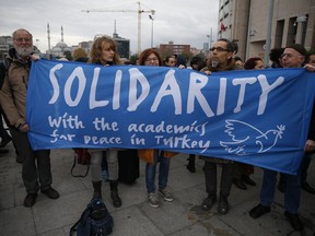 A delegation of academics and human rights activists from Germany participate in a protest outside a court in Istanbul, Tuesday, Dec. 5, 2017, where Turkish academics went on trial for signing a declaration calling for end of hostilities in Turkey's southeast. The so-called "Academics for Peace", a group of academics from universities in Istanbul, are standing trial on charges of engaging in "terrorist propaganda" for signing a declaration calling for an end of hostilities against Kurdish rebels in Turkey's southeast. Many of the academics lost their jobs.