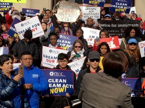 Pro-immigrant protesters listen to Democratic congresswoman Nydia Velazquez near the U.S. Capitol in Washington, D.C., on Wednesday, Dec. 6, 2017, at a rally demanding deportation relief for 800,000 young migrants amid a standoff that could prompt a U.S. federal government shutdown later this month.