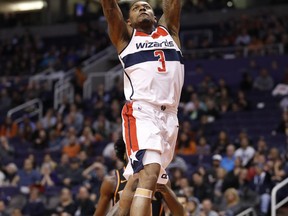 Washington Wizards guard Bradley Beal (3) dunks against the Phoenix Suns during the first half of an NBA basketball game, Thursday, Dec. 7, 2017, in Phoenix.