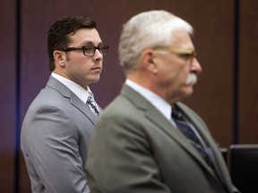 In this  Oct. 25, 2017  file photo, Former Mesa police officer Philip Brailsford, left, and his attorney, Mike Piccarreta, stand for the jury, at the start of Brailsford's murder trial at Maricopa County Superior Court in Phoenix . Brailsford was acquitted Thursday, Dec. 7, 2017 of a murder charge in the 2016 fatal shooting of Daniel Shaver, an unarmed man outside his hotel room as officers were responding to a call that someone there was pointing a gun out a window.