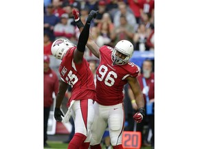 Arizona Cardinals outside linebacker Chandler Jones (55) celebrates a tackle against the Tennessee Titans with inside linebacker Kareem Martin (96) during the first half of an NFL football game, Sunday, Dec.10, 2017, in Glendale, Ariz.