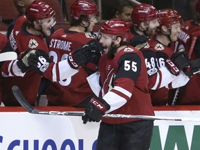Arizona Coyotes' Jason Demers (55) celebrates with teammates after scoring a goal against the New Jersey Devils during the first period of an NHL hockey game, Saturday, Dec. 2, 2017, in Glendale, Ariz.