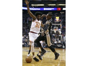 San Antonio Spurs guard Brandon Paul, right, loses the ball as he collides with Phoenix Suns' Josh Jackson during the first half of an NBA basketball game Saturday, Dec. 9, 2017, in Phoenix.
