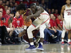 Arizona State guard Remy Martin, left, reaches to steal the ball from Arizona guard Rawle Alkins (1) during the first half of an NCAA college basketball game, Saturday, Dec. 30, 2017, in Tucson, Ariz.