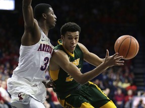 North Dakota State guard Tyson Ward, right, drives against Arizona guard Dylan Smith in the first half during an NCAA college basketball game, Monday, Dec 18, 2017, in Tucson, Ariz.