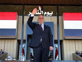 Iraqi Prime Minister Haider al-Abadi salutes security forces during an Iraqi military parade in Baghdad, Iraq, Sunday, Dec. 10, 2017. Al-Abadi formally announced the victory of hte military over IS forces, in an address to the nation aired on Iraqi state television Saturday evening. (Iraqi Prime Minister Press Office pool via AP)