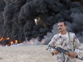 FILE - In this Sept. 13, 2005, file photo, an Iraqi soldier secures a burning pipeline near Kirkuk, 290 kilometers (180 miles) north of Baghdad, Iraq. Iraq has invited bidders to express interest to build an oil pipeline that sends crude to international market through Turkey's Mediterranean port of Ceyhan.