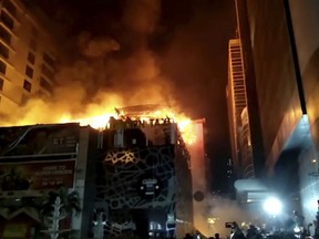 In this image made from video, a building is on fire in Mumbai, India, early Friday, Dec. 29, 2017. A number of people were killed and many more injured in a fire that broke out in a restaurant in Mumbai, India's financial and entertainment capital, early Friday, officials said.