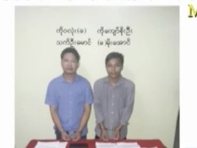 In this image released by the Myanmar Ministry of Information and broadcast by Myanmar's MRTV, on Dec. 13, 2017, Reuters reporters Wa Lone, left, and Kyaw Soe Oo stand handcuffed in Myanmar. Reuters news agency called on Myanmar to immediately release its two journalists who were arrested for possessing "important secret papers" obtained from two policemen who had worked in Rakhine state, where violence widely blamed on security forces has forced more than 625,000 minority Rohingya Muslims to flee into neighboring Bangladesh. (MRTV/Myanmar Ministry of Information via AP)