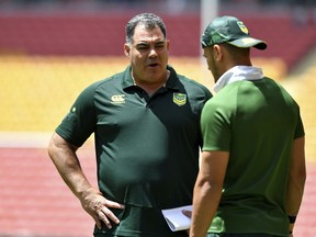 Australian Rugby League coach Mal Meninga left, talks to Valentine Holmes during the captains training run at Suncorp Stadium in Brisbane, Australia, Friday, Dec. 1, 2017. Meninga came prepared with photographic evidence in response to England coach Wayne Bennett's concerns about Australia's tactics ahead of Rugby League World Cup final to be played on Saturday Dec. 2. (Darren England/AAP Image via AP)