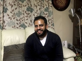 In this Nov. 21, 2017 photo, Irishman Ibrahim Halawa, who was recently acquitted after four years of imprisonment in Egypt, poses for a photograph at his home, in Dublin, Ireland. Halawa says he saw dozens of cellmates radicalize and adopt views of the so-called Islamic State during his brutal captivity in overcrowded jails.