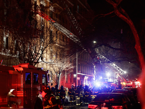 Firefighters respond to a building fire Thursday, Dec. 28, 2017, in the Bronx borough of New York.