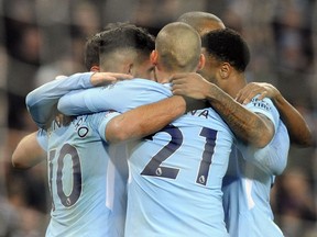 Manchester City's Sergio Aguero, left, celebrates with teammates after scoring his second goal, his side's third, during the English Premier League soccer match between Manchester City and Bournemouth at Etihad stadium, in Manchester, England, Saturday, Dec. 23, 2017.