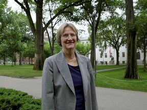 FILE - In this June 30, 2009, file photo, Harvard University President Drew Faust, the university's first female president, poses for a photograph on the university's campus in Cambridge, Mass. Harvard University is upholding a 2016 policy that pressures secretive all-male social clubs to accept students of any gender, its top leadership announced on Tuesday, Dec. 5, 2017. Faust said the overall impact of gender-exclusive groups has been negative.