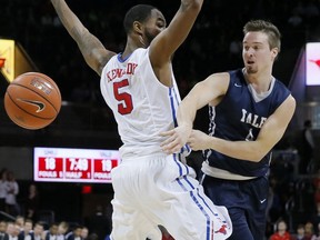 FILE - In this Nov. 22, 2015 FILE photo, Yale's Jack Montague, right, passes the ball around SMU's Markus Kennedy during an NCAA college basketball game in Dallas. Court documents show that Yale alumni are helping fund a lawsuit filed by Montague, who was expelled from the school for sexual misconduct.  Montague told attorneys in a court deposition that between $25,000 and $30,000 has been raised from alumni to help fund the lawsuit, in which he claims he was wrongly expelled in 2016. He is seeking monetary damages and to be readmitted to the Ivy League school.