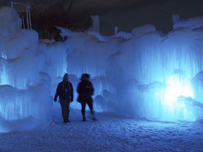 FILE - In this Jan. 8, 2014, file photo, patrons tour an ice castle at the base of the Loon Mountain ski resort in Lincoln, N.H. The ice castles are expected to be open again in January 2018.