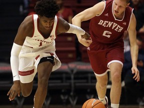 Stanford's Daejon Davis, left, and Denver's Joe Rosga (2) chase the ball during the first half of an NCAA college basketball game Friday, Dec. 15, 2017, in Stanford, Calif.