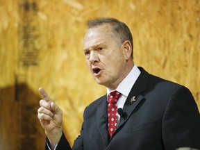 FILE - In this Thursday, Nov. 30, 2017 file photo, former Alabama Chief Justice and U.S. Senate candidate Roy Moore speaks at a campaign rally, in Dora, Ala. Federal fundraising reports released Friday, Dec. 1, reveal that Moore is losing the battle for campaign cash to Democrat Doug Jones. And he's losing badly.
