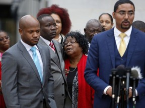 FILE - In this Monday, Dec. 5, 2016, file photo, Judy Scott, center, Walter Scott's mother, is comforted by her son Rodney Scott, as the family attorneys, Chris Stewart, left, and Justin Bamberg, right, hold a press conference after a mistrial was declared in former South Carolina officer, Michael Slager's trial in Charleston, S.C.  Slager, who fatally shot a black motorist, Walter Scott, in 2015, could learn his fate as soon as his federal sentencing hearing winds down. On Thursday, Dec. 7, 2017, attorneys are expected to call friends and relatives of both men who'll tell the judge how Scott's death and the officer's arrest have impacted their lives.