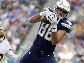 Los Angeles Chargers tight end Hunter Henry makes a touchdown catch during the first half of an NFL football game as Washington Redskins safety Deshazor Everett looks on Sunday, Dec. 10, 2017, in Carson, Calif.