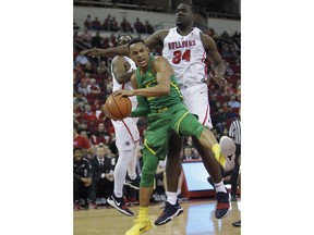 Oregon's Elijah Brown goes up against Fresno State's Terrell Carter II in the first half of an NCAA college basketball game in Fresno, Calif., Saturday, Dec. 16, 2017.