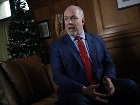 Premier John Horgan answers questions during a year end interview at his office at Legislature in Victoria, B.C., on Tuesday, December 12, 2017. Premier John Horgan says marijuana users in British Columbia could face the same rules as those who smoke tobacco in public.
