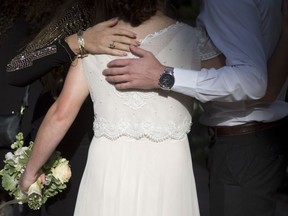 In this Thursday, Dec. 14, 2017 photo, a bride hugs her friends during her wedding in Ein Hemed. A growing number of Israeli couples are defying the country's Chief Rabbinate and marrying in unsanctioned weddings. The couples include people who have difficulty proving their Jewishness to the strict rabbinic authorities, but many are simply fed up with the establishment's monopoly over an intimate and emotional custom.