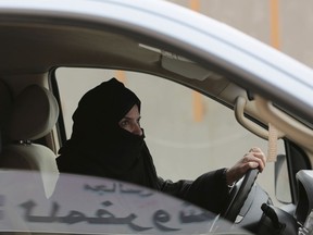 FILE - In this Saturday, March 29, 2014 file photo, Aziza Yousef drives a car on a highway in Riyadh, Saudi Arabia, as part of a campaign to defy Saudi Arabia's ban on women driving. This past year, Saudi Arabia laid the groundwork for momentous change next year in the conservative kingdom, defying its own reputation for slow-paced, cautious reforms.