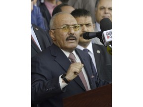 FILE - In this Aug. 24, 2017 file photo, former Yemeni President Ali Abdullah Saleh speaks during a ceremony to celebrate the 35th anniversary of the founding of the Popular Conference Party, in Sanaa, Yemen. Yemenis in the war-torn country's capital crowded into basements overnight, Monday Dec. 4, 2017, as Saudi-led fighter jets pounded the positions of Houthi rebels, who are now fighting forces loyal to Saleh for control of the city. A Sanaa-based protection and advocacy adviser for the Norwegian Refugee Council said Monday that the violence left aid workers trapped inside their homes and was "completely paralyzing humanitarian operations."