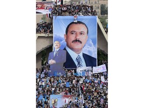 FILE - In this Aug. 24, 2017 file photo, supporters of former Yemeni President Ali Abdullah Saleh attend a ceremony to celebrate the 35th anniversary of the founding of the Popular Conference Party, in Sanaa, Yemen, Aug. 24, 2017. Yemenis in the war-torn country's capital crowded into basements overnight, Monday Dec. 4, 2017, as Saudi-led fighter jets pounded the positions of Houthi rebels, who are now fighting forces loyal to Saleh for control of the city. A Sanaa-based protection and advocacy adviser for the Norwegian Refugee Council said Monday that the violence left aid workers trapped inside their homes and was "completely paralyzing humanitarian operations."