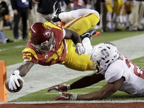 Southern California running back Ronald Jones II, top, dives next to Stanford linebacker Bobby Okereke during the first half of the Pac-12 Conference championship NCAA college football game in Santa Clara, Calif., Friday, Dec. 1, 2017. The play was called back on a penalty.